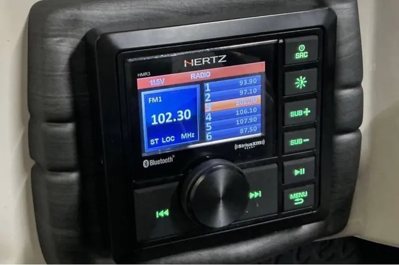 Slide: The Image of Hertz HMR3 radio display in 2021 Barletta E24UC, showing FM frequency 102.30 MHz. - 14