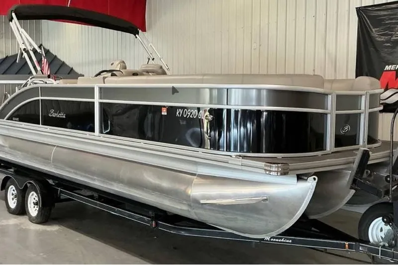 Slide: The Image of 2021 Barletta E24UC pontoon boat on trailer in indoor showroom. - 4