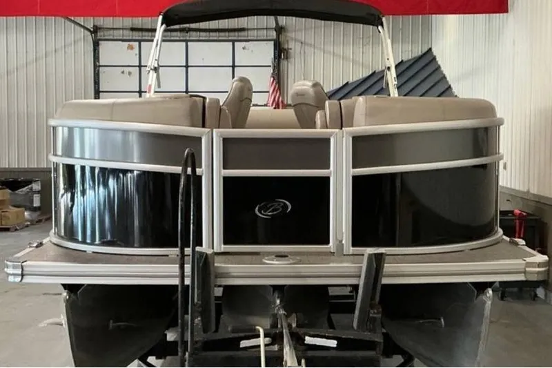 Slide: The Image of 2021 Barletta E24UC pontoon boat in a garage, front view. - 5