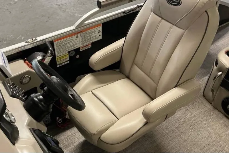 Slide: The Image of Captain's chair in a 2021 Barletta E24UC boat, featuring beige upholstery and ergonomic design. - 7