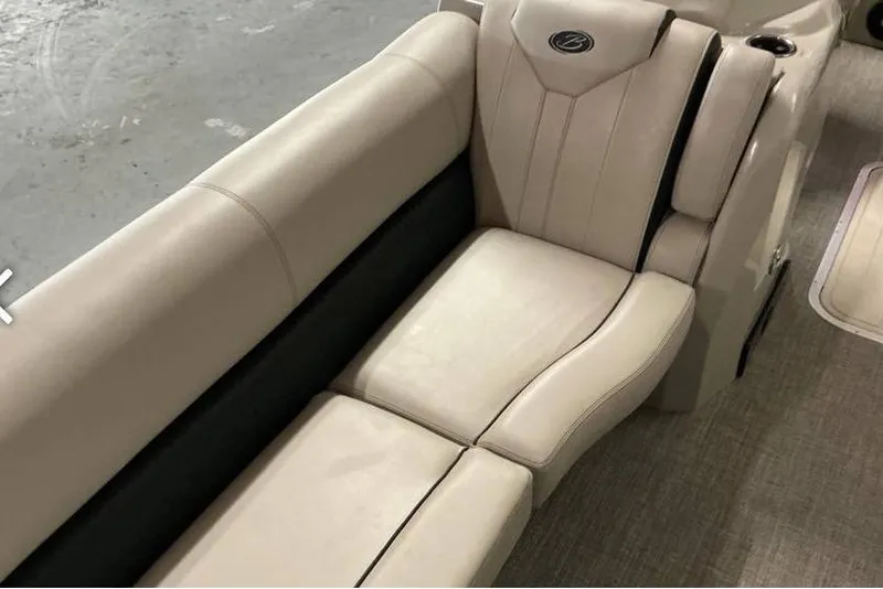 Slide: The Image of 2021 Barletta E24UC boat interior with beige leather seating and elegant design. - 8