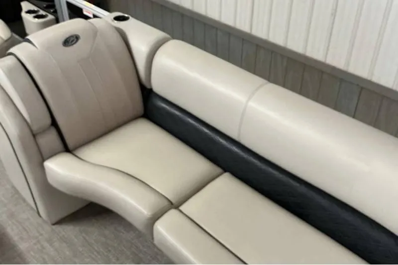 Slide: The Image of 2021 Barletta E24UC boat interior seating, featuring beige and black upholstery. - 9