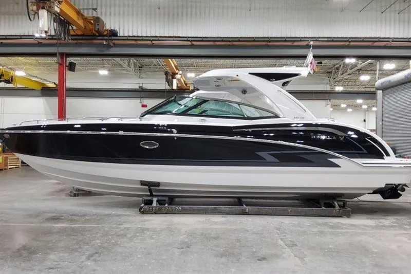 The Image of 2025 Formula 350 Crossover Bowrider I/O in a warehouse setting. - 0