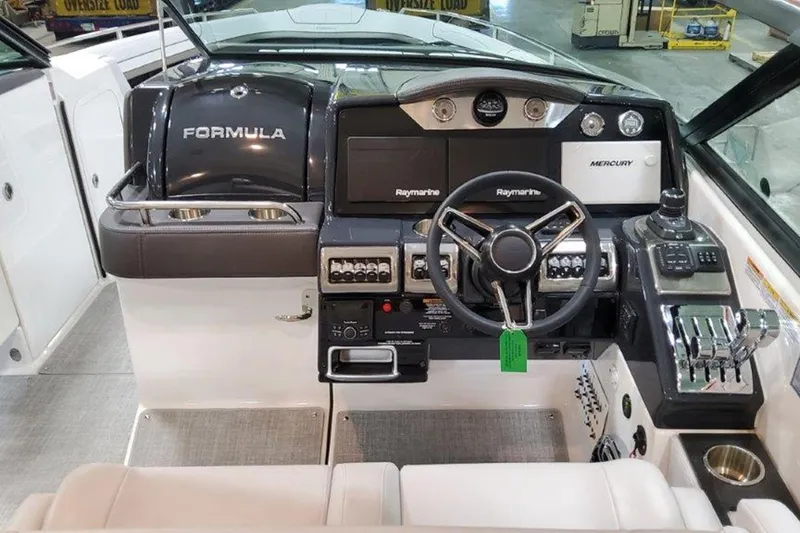 Slide: The Image of 2025 Formula 350 Crossover Bowrider I/O dashboard with steering wheel and control panel. - 11