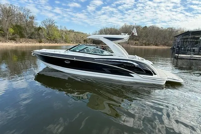 Slide: The Image of 2025 Formula 350 Crossover Bowrider I/O on calm lake under blue sky. - 14