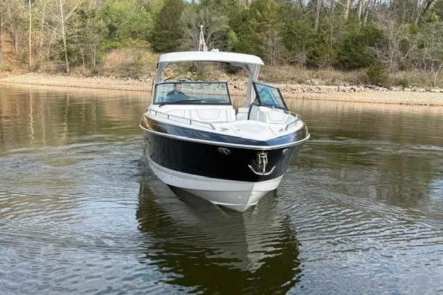 Slide: The Image of 2025 Formula 350 Crossover Bowrider I/O on calm water, surrounded by trees. - 16