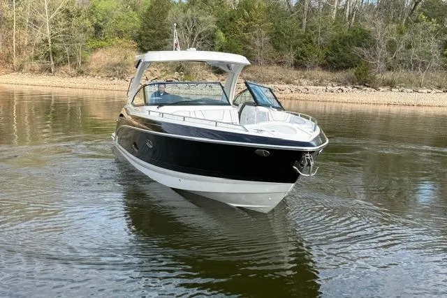 Slide: The Image of 2025 Formula 350 Crossover Bowrider I/O on calm water, surrounded by trees. - 17