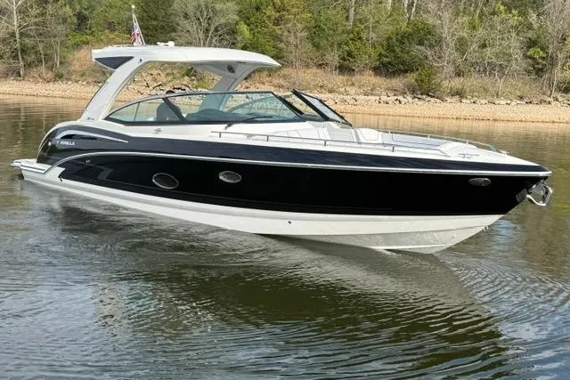 Slide: The Image of 2025 Formula 350 Crossover Bowrider I/O on a calm lake, surrounded by trees. - 19