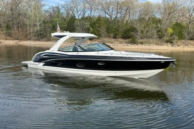 Slide: The Image of 2025 Formula 350 Crossover Bowrider I/O on calm water, surrounded by trees. - 21
