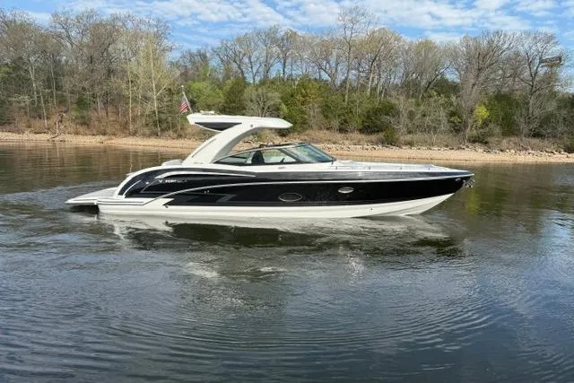 Slide: The Image of 2025 Formula 350 Crossover Bowrider I/O cruising on a calm lake with wooded shoreline. - 23