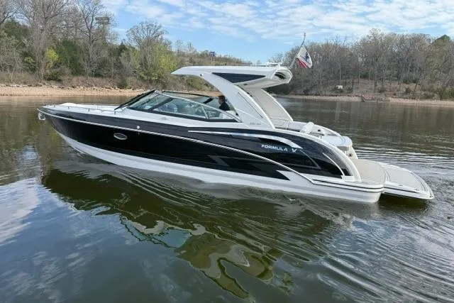 Slide: The Image of 2025 Formula 350 Crossover Bowrider I/O on a calm lake, showcasing sleek design and luxury features. - 25
