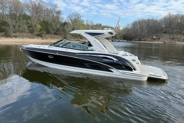 Slide: The Image of 2025 Formula 350 Crossover Bowrider I/O on a serene lake with wooded shoreline. - 26