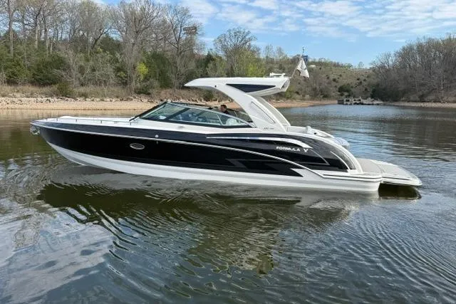 Slide: The Image of 2025 Formula 350 Crossover Bowrider I/O on a calm lake with scenic background. - 27