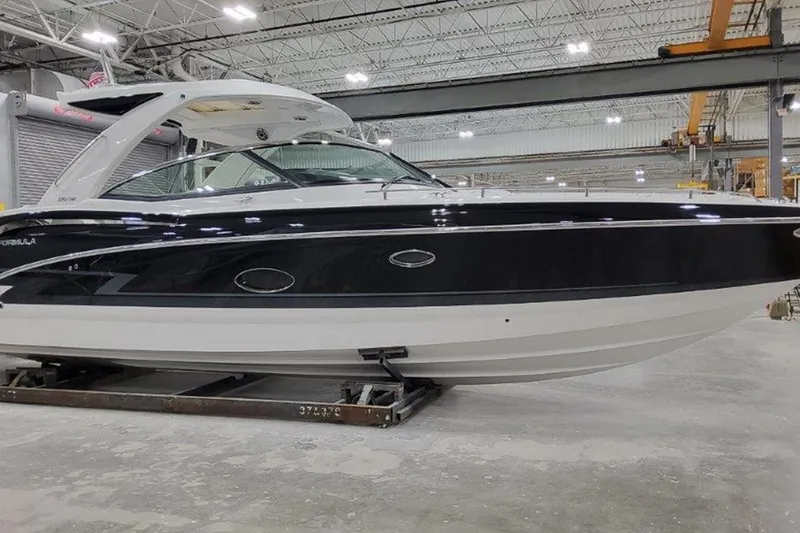 Slide: The Image of 2025 Formula 350 Crossover Bowrider I/O in a spacious indoor facility. - 3