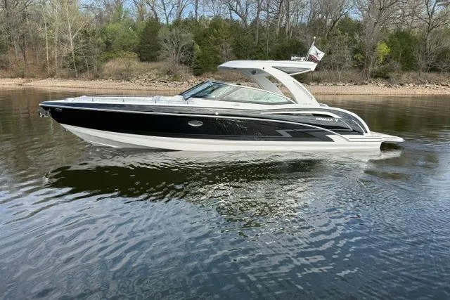 Slide: The Image of 2025 Formula 350 Crossover Bowrider I/O on calm water, sleek black and white design. - 30