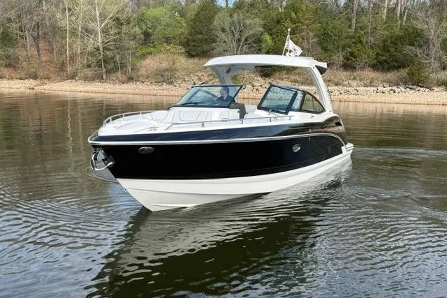 Slide: The Image of 2025 Formula 350 Crossover Bowrider I/O on calm water, surrounded by trees. - 34