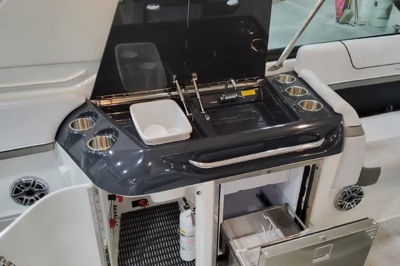 Slide: The Image of 2025 Formula 350 Crossover Bowrider I/O boat interior with kitchenette and storage. - 6