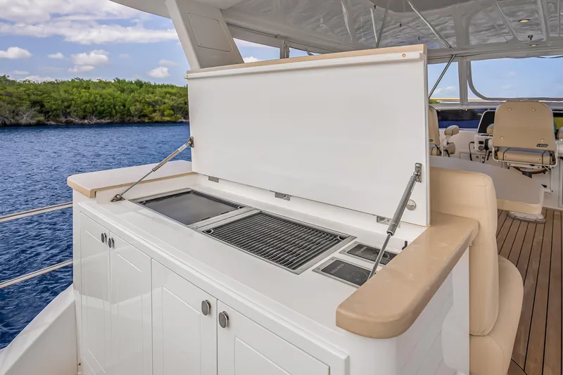 Slide: The Image of Outdoor kitchen on 2023 Grand Banks GB54 yacht with grill and seating. - 25