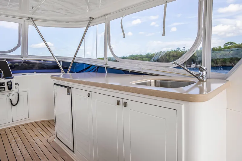 Slide: The Image of 2023 Grand Banks GB54 yacht interior with sink and cabinetry, featuring sleek design and natural light. - 29