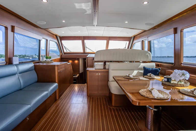 Slide: The Image of Luxurious interior of 2023 Grand Banks GB54 yacht with elegant wood finishes and seating. - 3