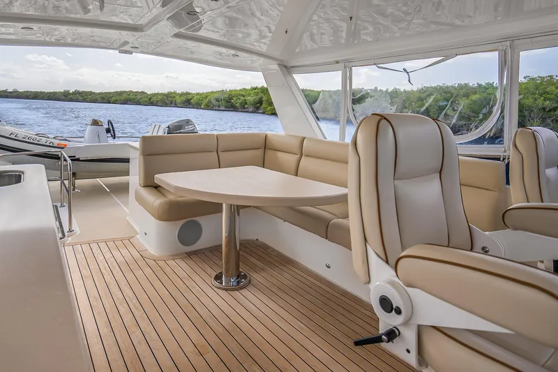 Slide: The Image of Luxurious 2023 Grand Banks GB54 yacht interior with elegant seating and scenic water view. - 30