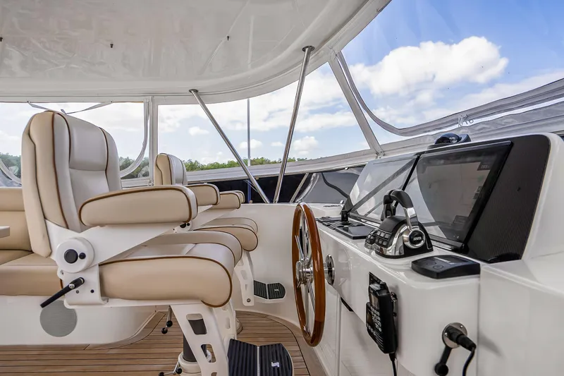 Slide: The Image of 2023 Grand Banks GB54 yacht helm with luxurious seating and advanced navigation equipment. - 33