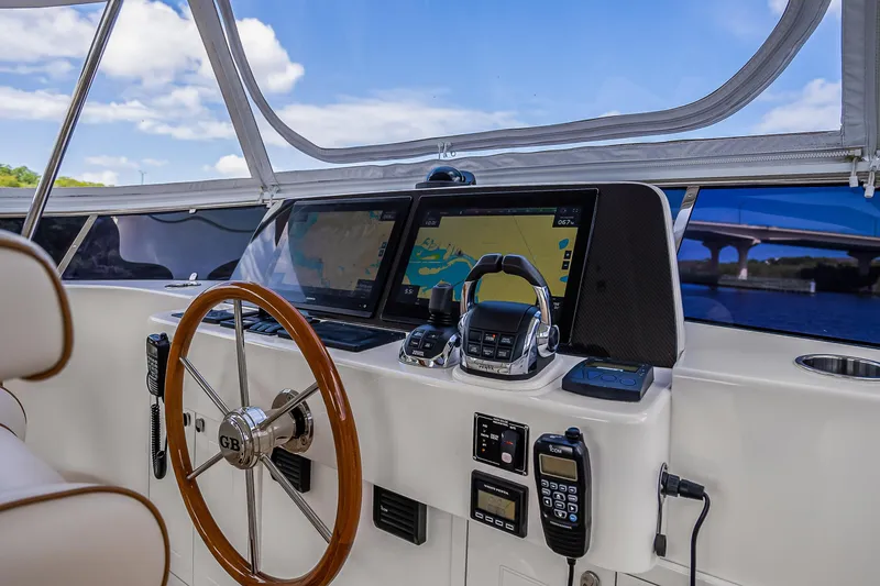 Slide: The Image of 2023 Grand Banks GB54 helm with navigation screens and steering wheel. - 36
