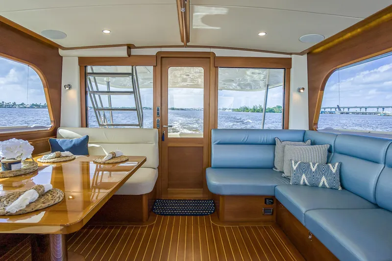 Slide: The Image of Luxurious interior of 2023 Grand Banks GB54 yacht with elegant seating and dining area. - 38