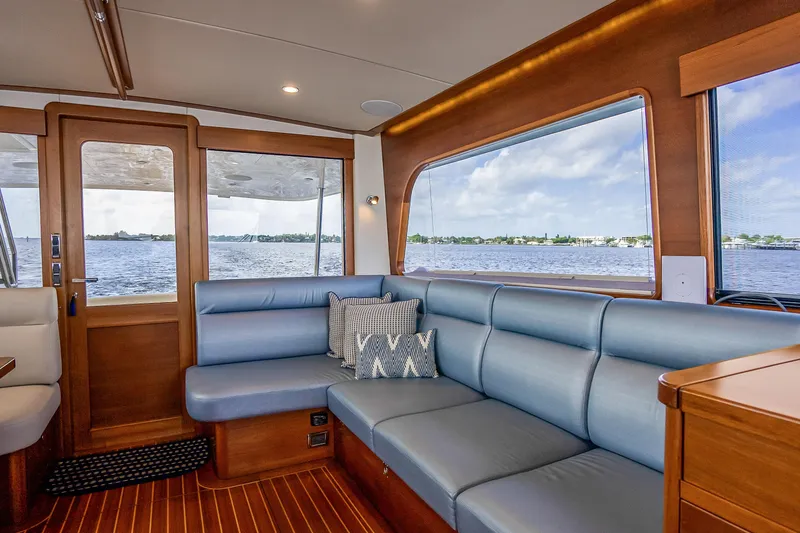 Slide: The Image of Luxurious interior of 2023 Grand Banks GB54 yacht with blue seating and scenic water view. - 39