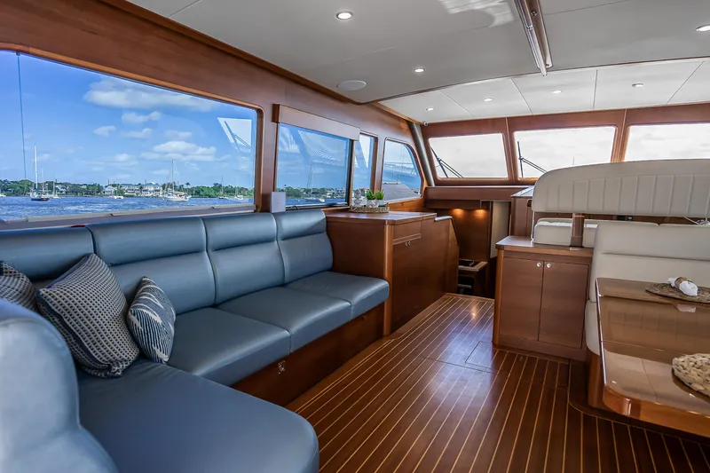 Slide: The Image of Luxurious interior of 2023 Grand Banks GB54 yacht with elegant seating and scenic windows. - 40