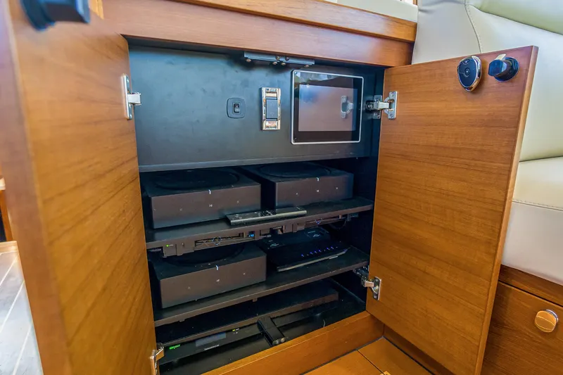 Slide: The Image of Open cabinet on 2023 Grand Banks GB54 yacht revealing electronic equipment. - 43