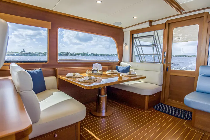 Slide: The Image of Luxurious interior of 2023 Grand Banks GB54 yacht with elegant dining area and scenic ocean view. - 44