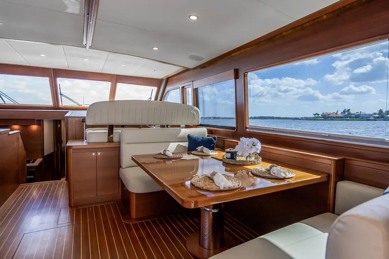 Slide: The Image of Luxurious 2023 Grand Banks GB54 yacht interior with elegant dining area and scenic ocean views. - 46
