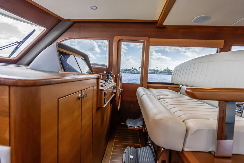 Slide: The Image of Interior of 2023 Grand Banks GB54 yacht with luxurious seating and navigation controls. - 47
