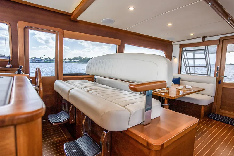 Slide: The Image of Luxurious interior of 2023 Grand Banks GB54 yacht with elegant seating and dining area. - 48