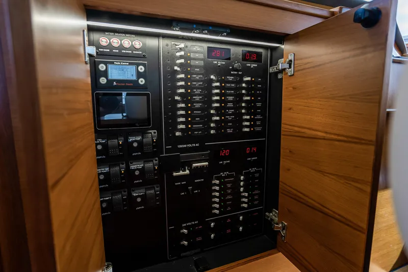 Slide: The Image of Electrical panel inside 2023 Grand Banks GB54 yacht, showcasing control switches and meters. - 49