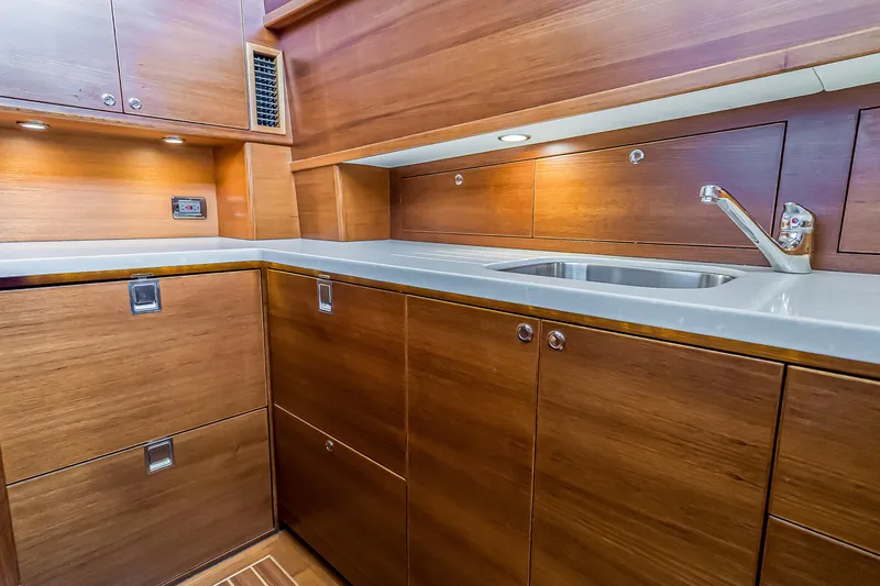 Slide: The Image of Luxurious wooden kitchen interior of 2023 Grand Banks GB54 yacht with modern sink. - 58