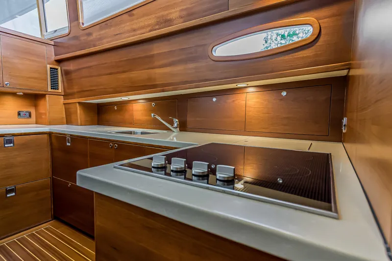 Slide: The Image of Luxurious 2023 Grand Banks GB54 yacht kitchen with modern appliances and elegant wood finish. - 60