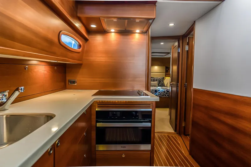 Slide: The Image of Luxurious 2023 Grand Banks GB54 yacht interior with modern kitchen and cozy cabin. - 61