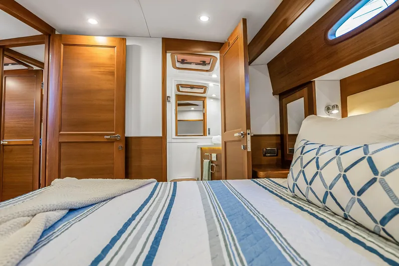 Slide: The Image of Luxurious 2023 Grand Banks GB54 yacht cabin with elegant wood finishes and modern amenities. - 66