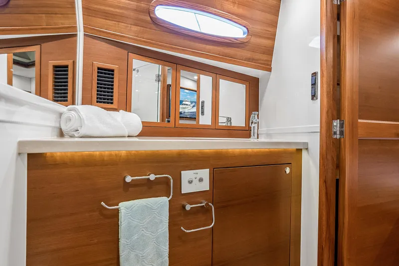Slide: The Image of Luxurious 2023 Grand Banks GB54 yacht bathroom with wooden cabinetry and modern fixtures. - 70
