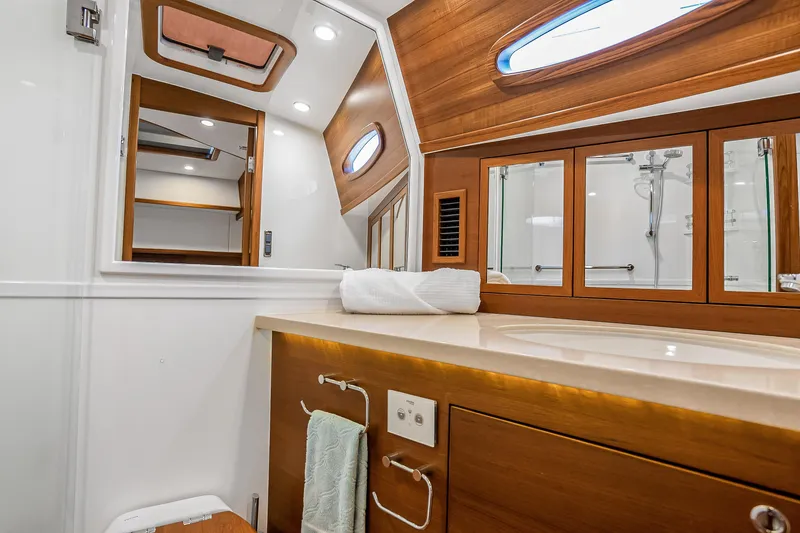 Slide: The Image of Luxurious 2023 Grand Banks GB54 yacht bathroom with wood accents and modern fixtures. - 71