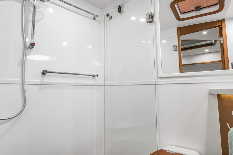 Slide: The Image of Modern bathroom interior of 2023 Grand Banks GB54 yacht, featuring sleek white design and fixtures. - 72