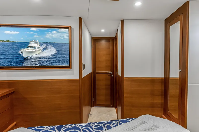 Slide: The Image of Luxurious 2023 Grand Banks GB54 yacht interior with wood accents and nautical decor. - 75