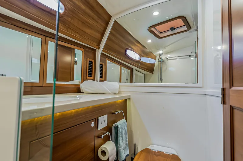 Slide: The Image of Luxurious 2023 Grand Banks GB54 yacht bathroom with wood accents and modern fixtures. - 77