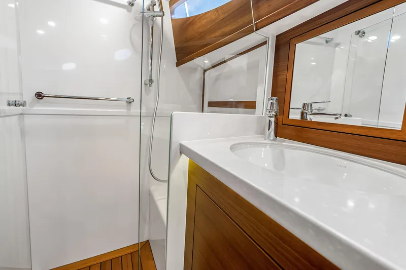 Slide: The Image of Luxurious bathroom in 2023 Grand Banks GB54 yacht, featuring sleek wood accents and modern fixtures. - 78
