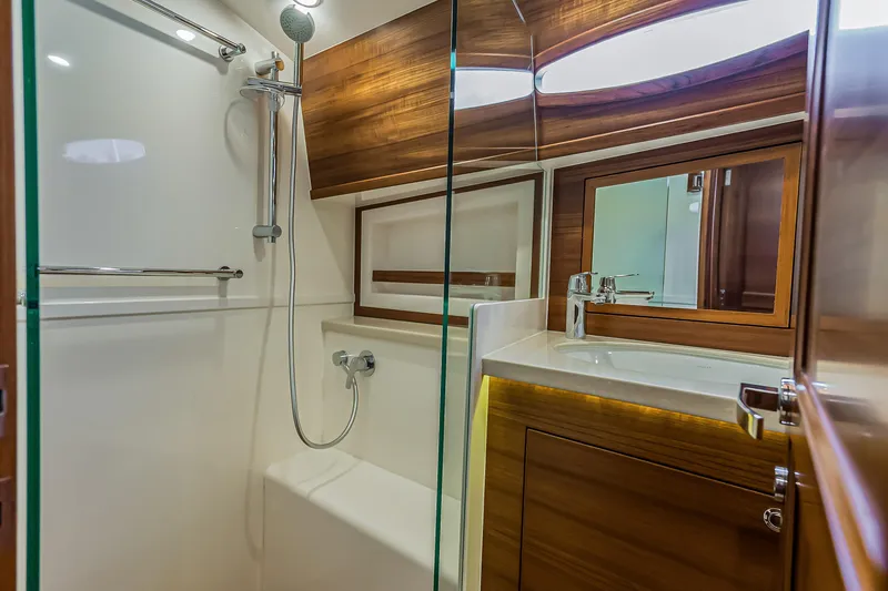 Slide: The Image of Luxurious bathroom in 2023 Grand Banks GB54 yacht with modern shower and wooden accents. - 79