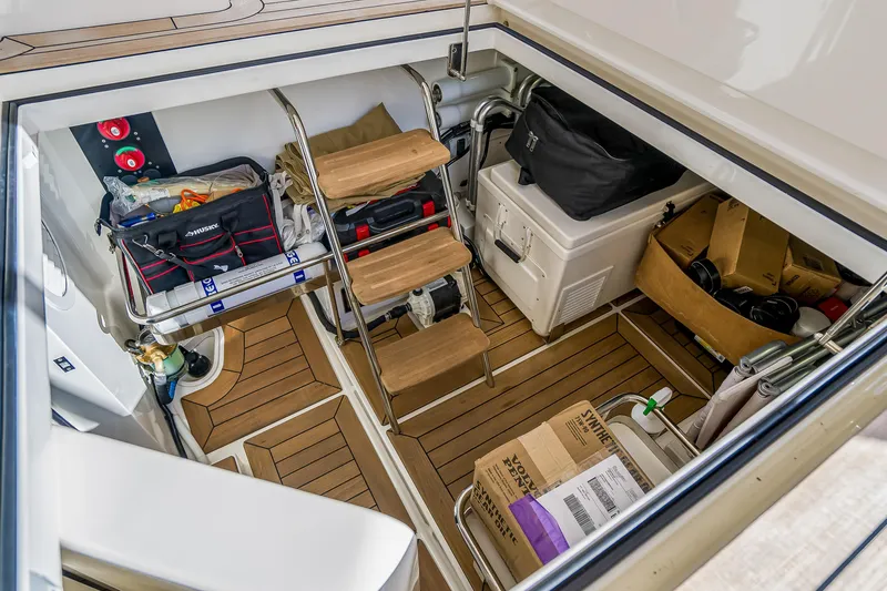 Slide: The Image of Storage area of 2023 Grand Banks GB54 yacht with wooden steps and equipment. - 80