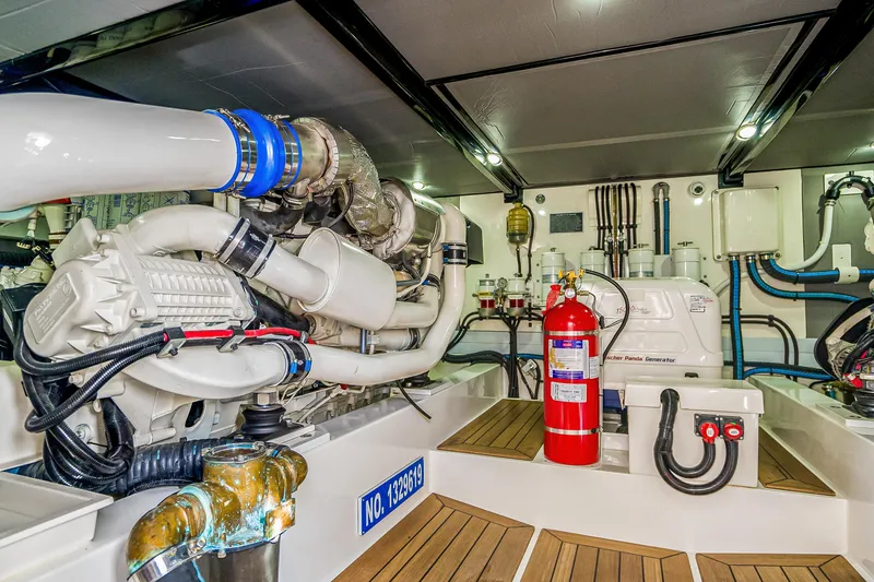Slide: The Image of Engine room of 2023 Grand Banks GB54 yacht, featuring advanced machinery and safety equipment. - 82