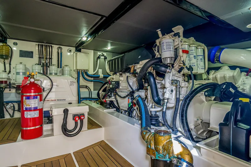 Slide: The Image of Engine room of 2023 Grand Banks GB54 yacht, featuring advanced machinery and fire safety equipment. - 83